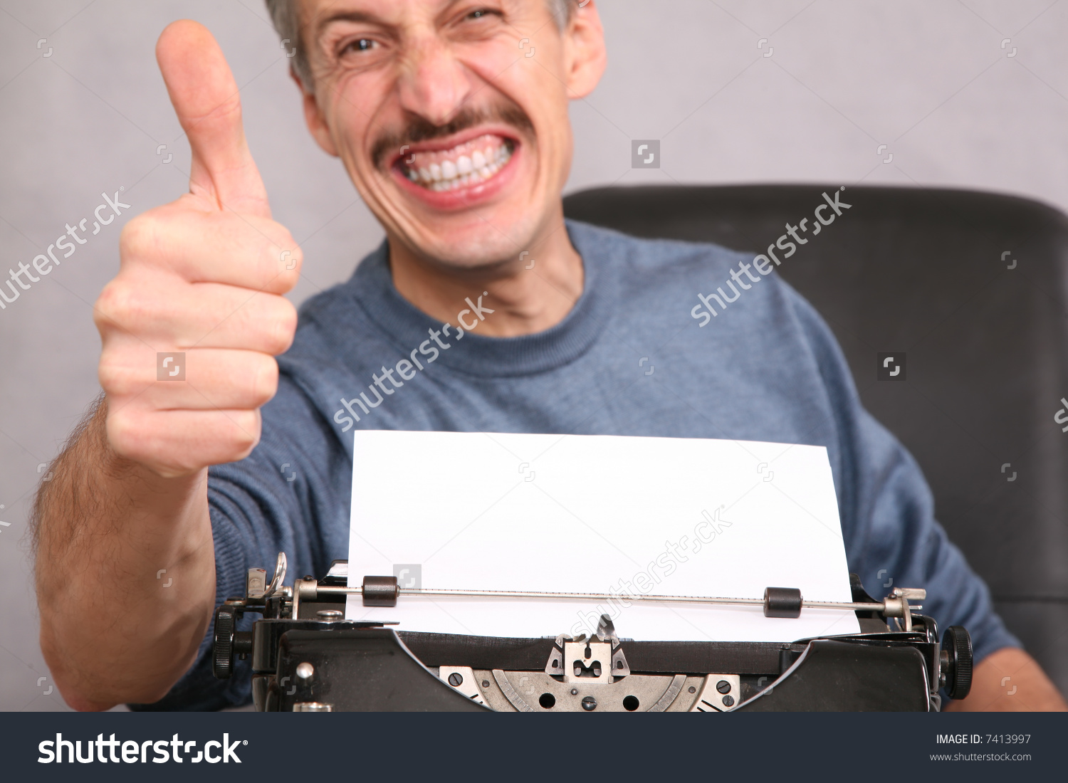 stock-photo-man-after-the-typewriter-shows-gesture-by-the-finger-7413997