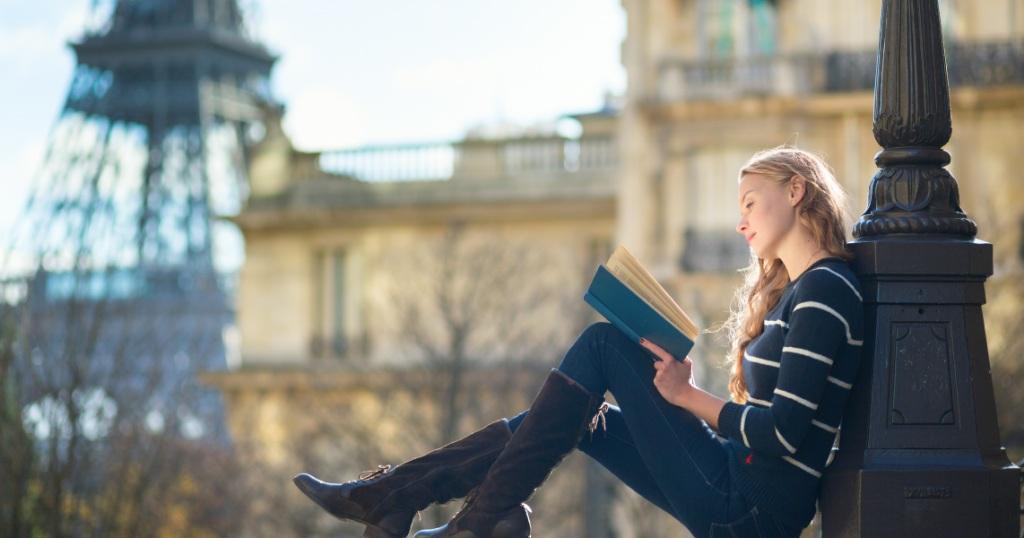 Beautiful-young-woman-in-Paris-reading-a-book